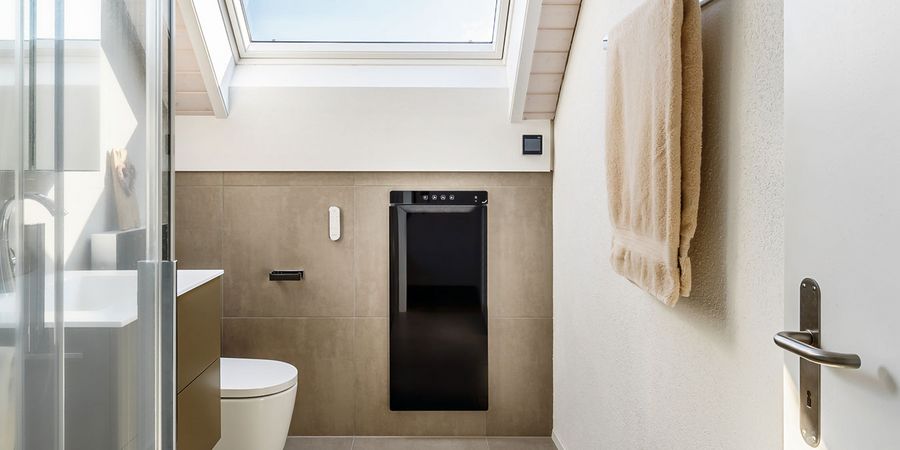 Blick durch die Badtür in das neu renovierte Bad mit Wärmekomfortgerät Zehnder Zenia