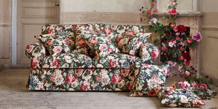 Sofa mit Blumenmuster und Kissen im Landhausstil.